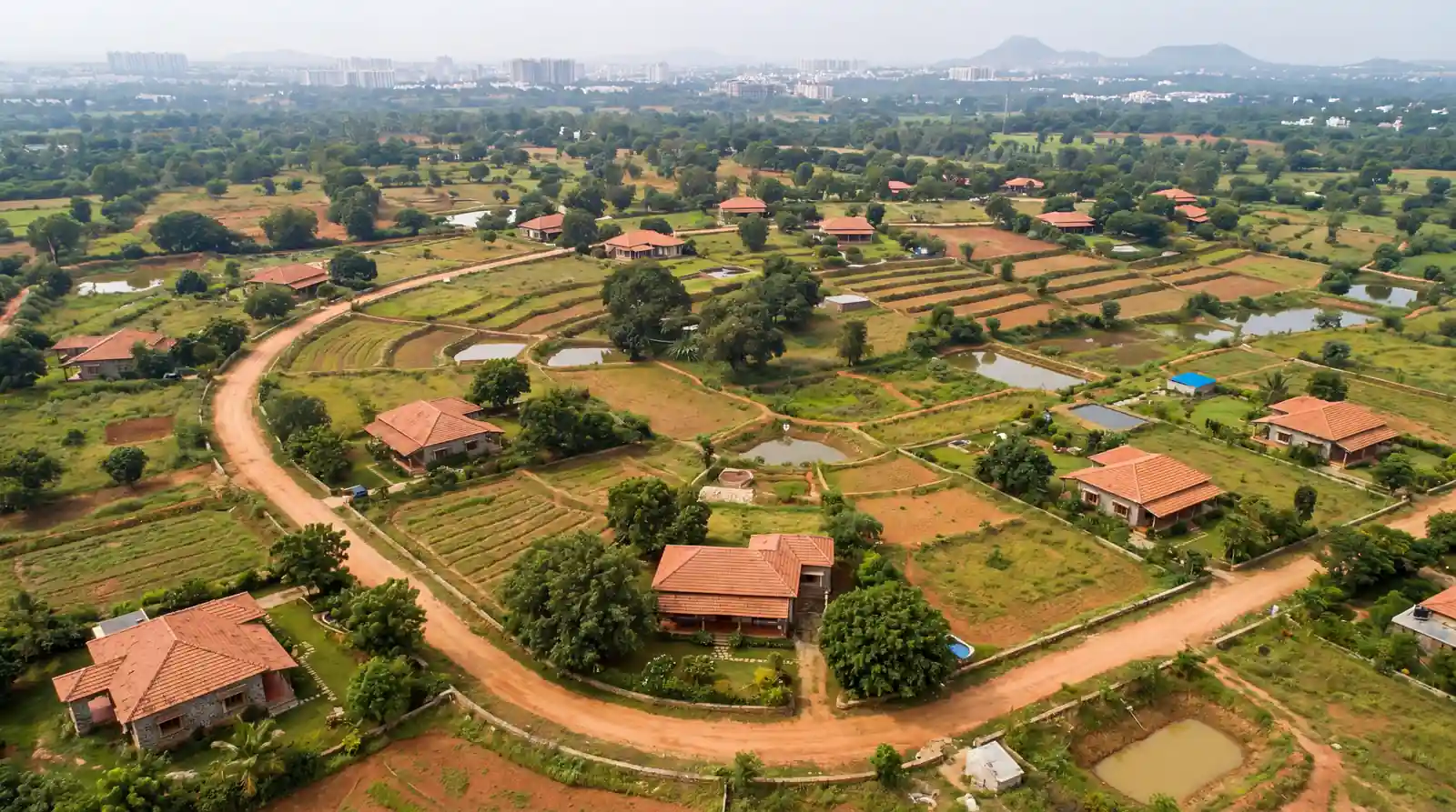 Aerial view — farmhouse near Amaravati capital, green estate roads and plotted farmhouse lots in Andhra Pradesh